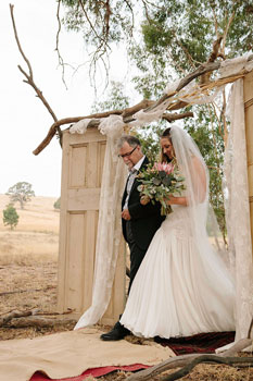 bride walking with her dad  at ceremony