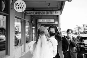 bride and groom wearing a covid mask