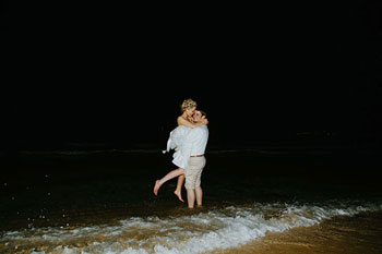 bride and groom hugging at the beach