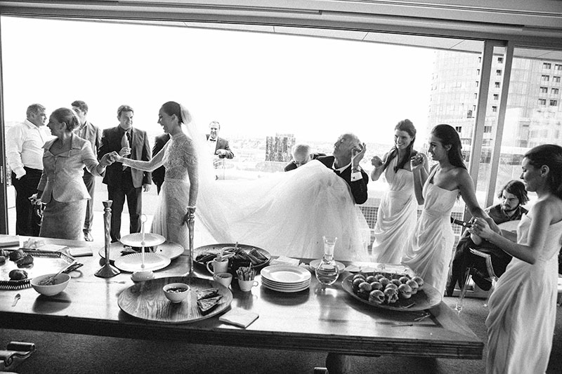 bride and family and friends dancing around the table