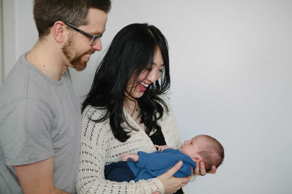 parents at home holding a newborn