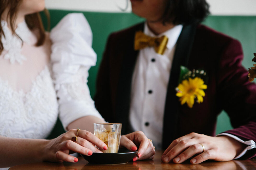 bride and groom drinking a coffee