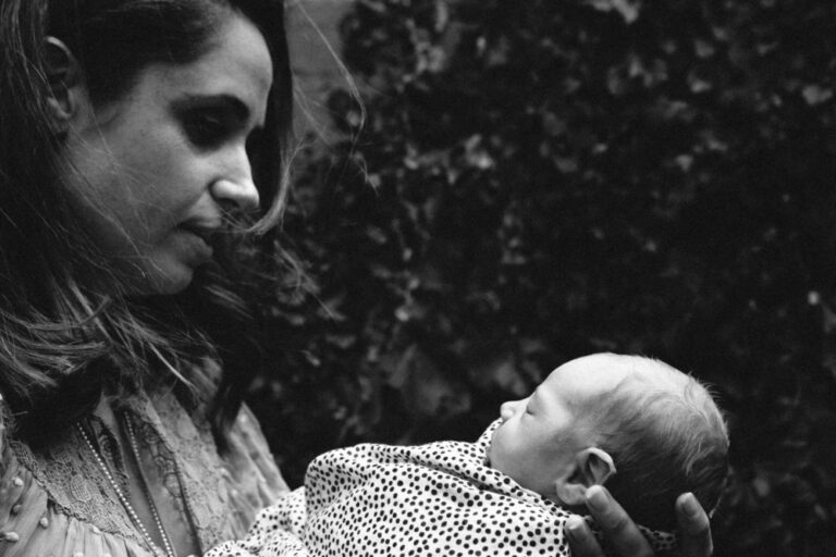 portrait of a mother holding her newborn in her hands