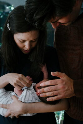 Parent holding their newborn.