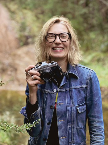 steph the photographer holding a vintage camera 