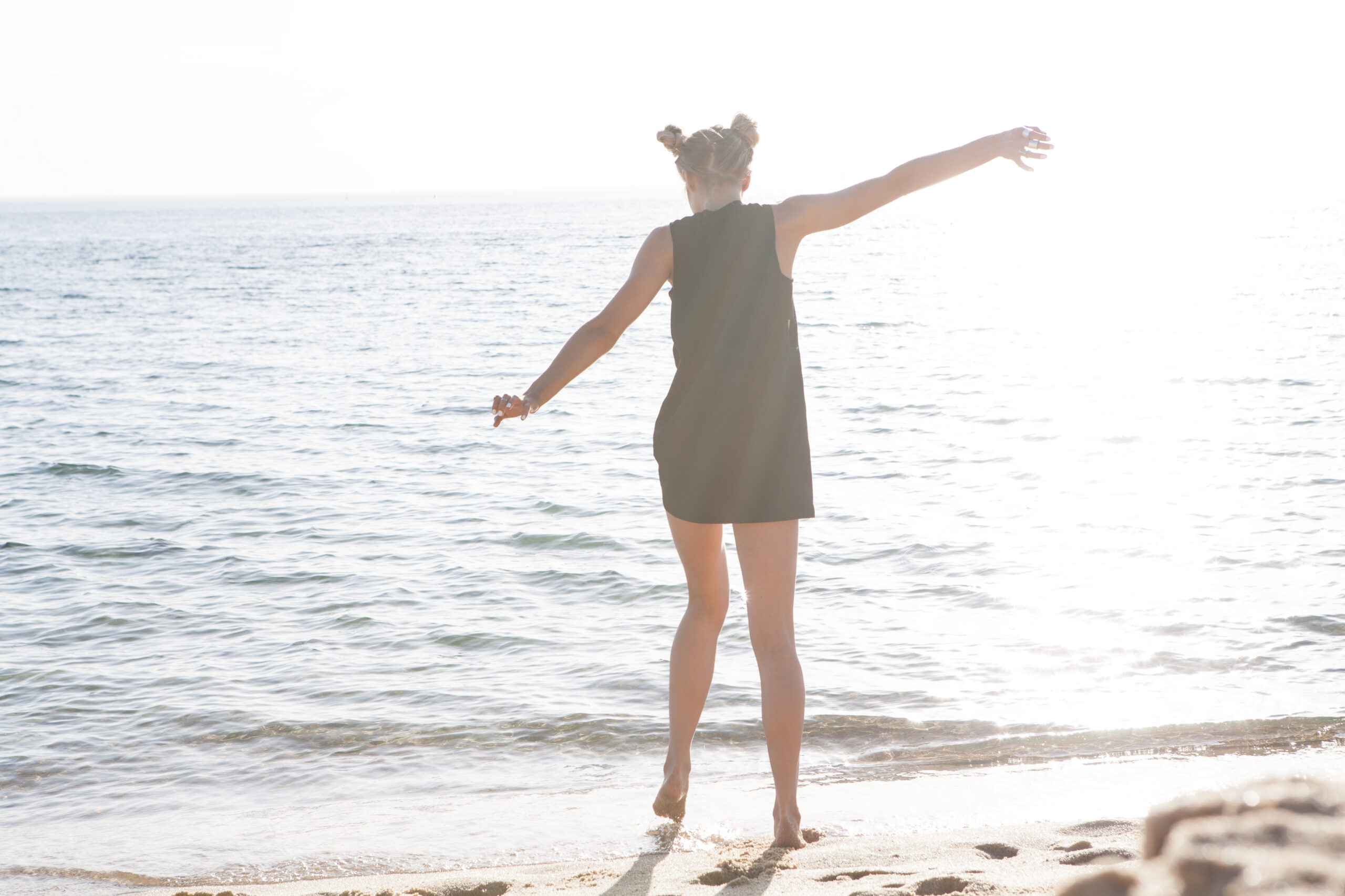 young woman walking along the beach in Melbourne